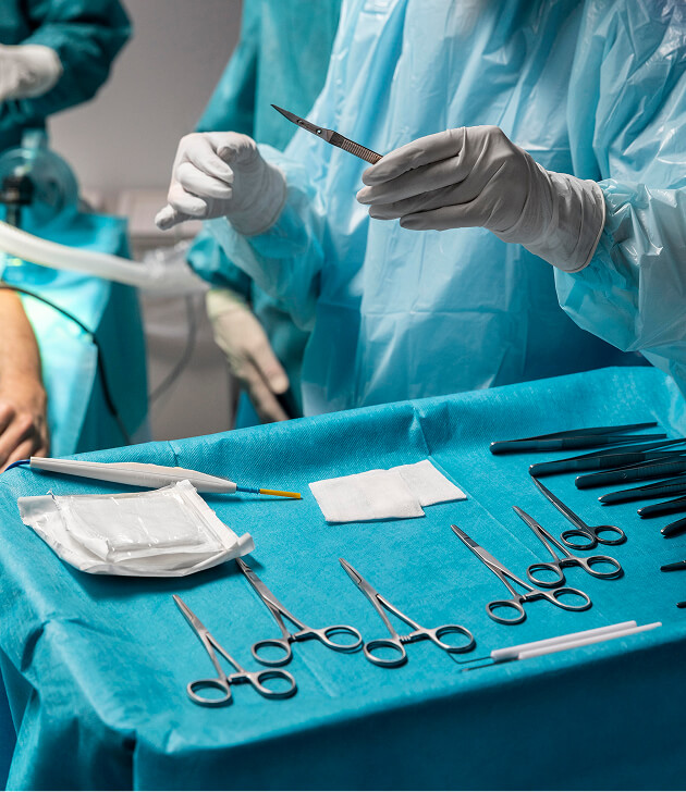 Doctors performing surgery under bright lights in an operating room
