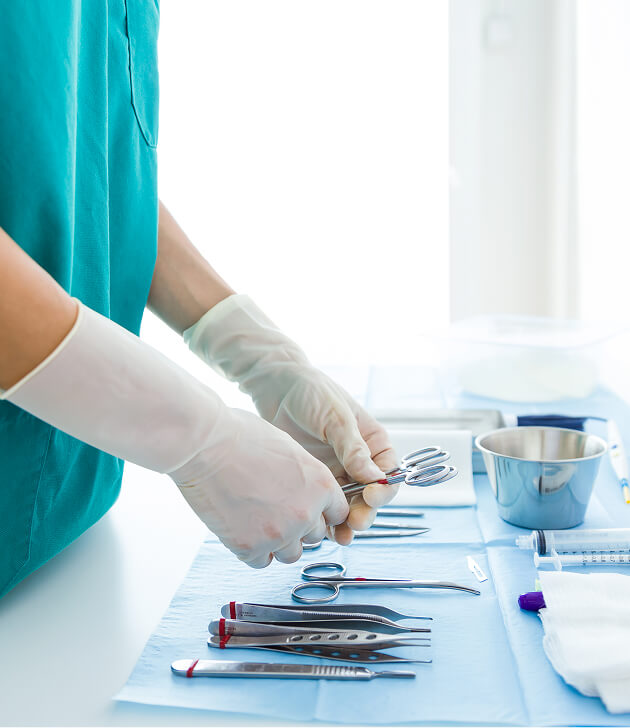 Doctors performing surgery under bright lights in an operating room