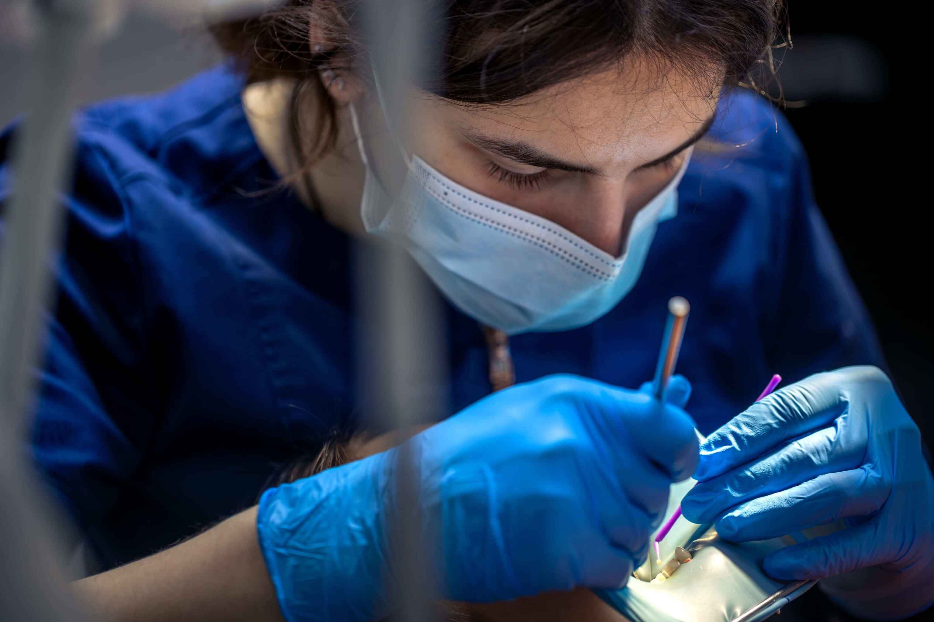 Doctors performing surgery under bright lights in an operating room